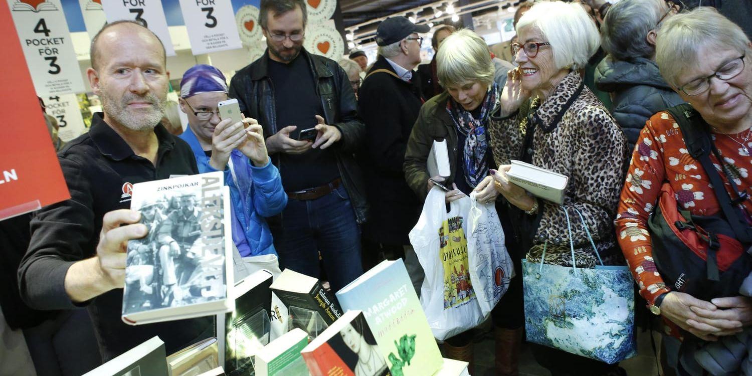 Försäljare på Akademibokhandeln håller i en bok av den vitryska författaren Svetlana Aleksijevitj som tilldelades Nobelpris i litteratur 2015. Arkivbild.